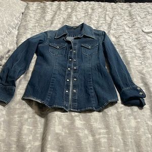 Dark blue jean shirt with bottoms on wrist